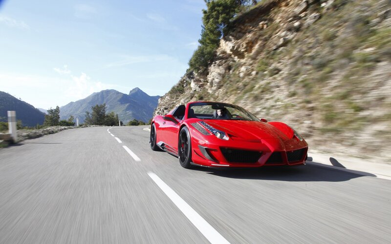 Red sports car on mountain road