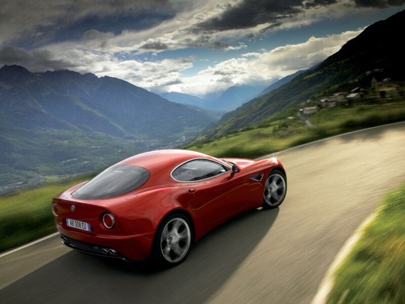 Red sports car on mountain road