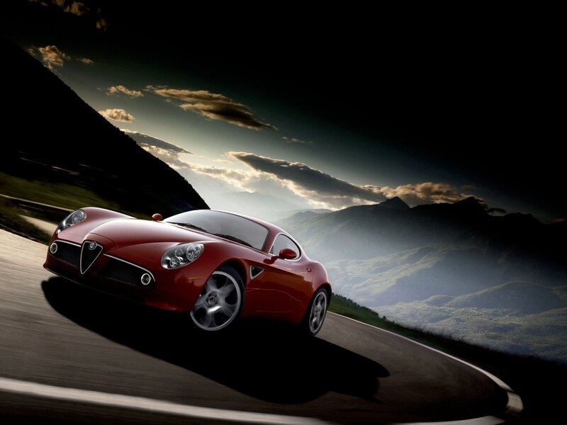 Red sports car on mountain road