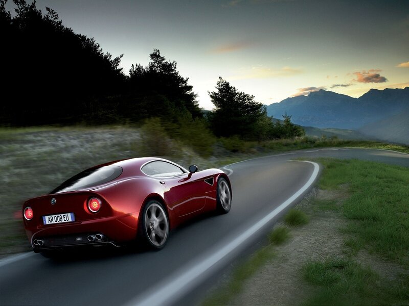 Red sports car on mountain road