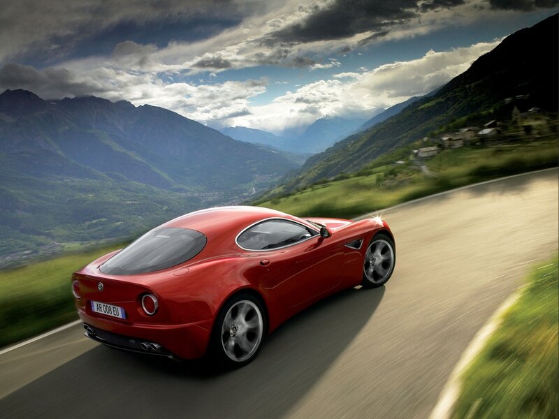 Red sports car on mountain road