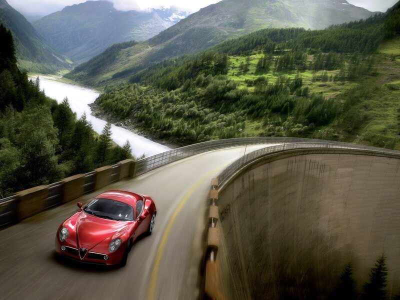 Red sports car on mountain road