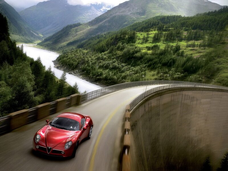 Red sports car on mountain road