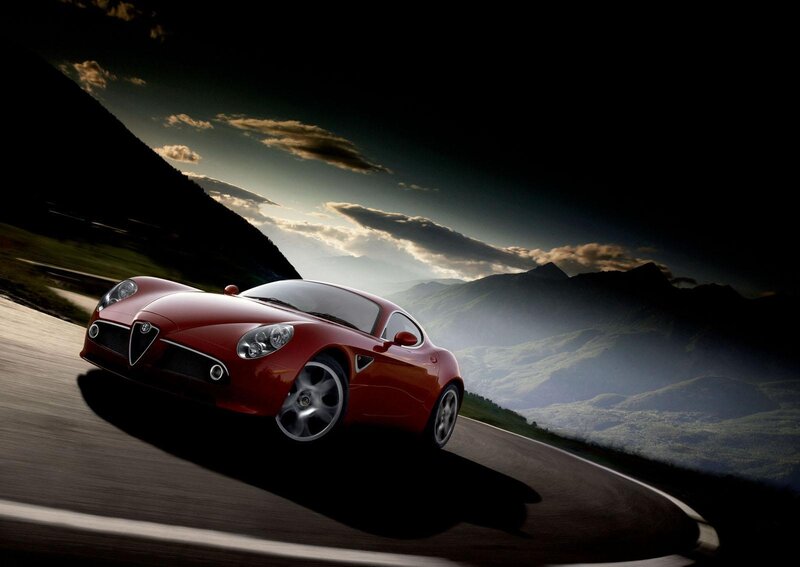 Red sports car on mountain road