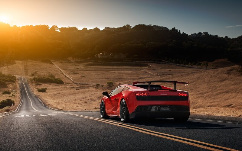 Red Sports Car on Road — Dramatic, Sunrise, Photograph