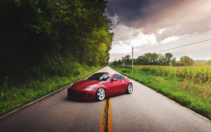 Red Sports Car on Road — Dramatic, Sunset, Photograph, Trees