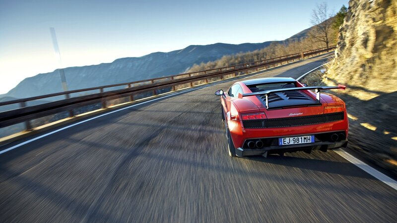 Red Sports Car on Road — Dynamic, Afternoon, Photograph, Mountains, Guardrail, Gray