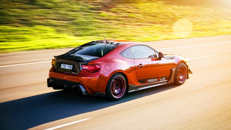 Red Sports Car on Road — Dynamic, Sunset, Photograph, Grass, Sun