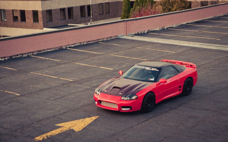 Red sports car on rooftop parking
