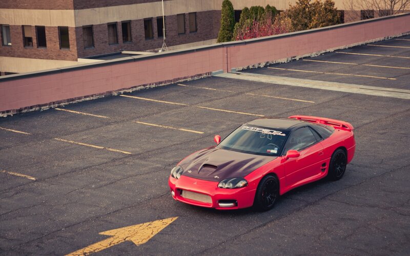 Red sports car on rooftop parking