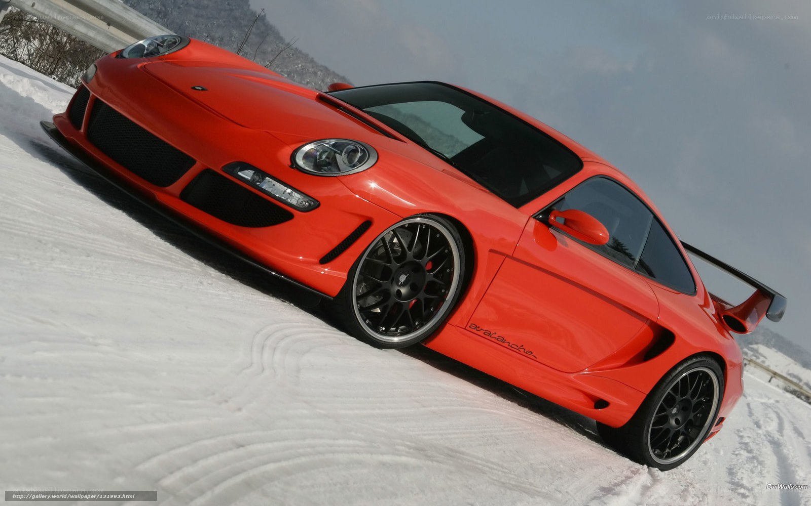 red sports car on snowy hill