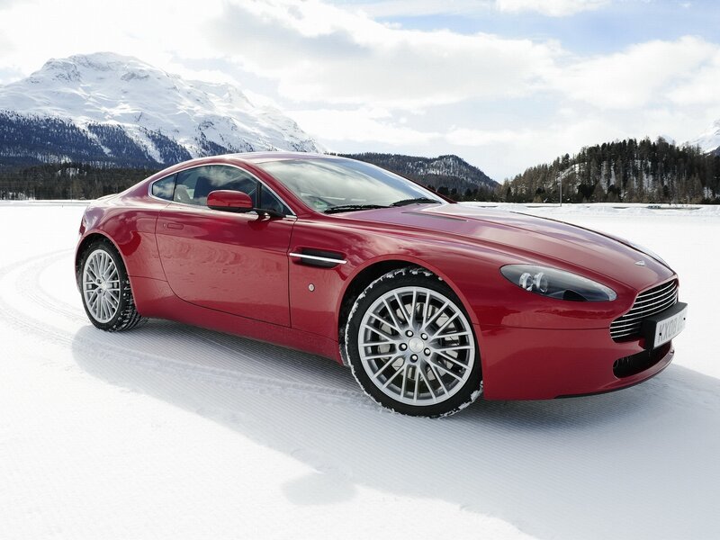 Red sports car on snowy landscape