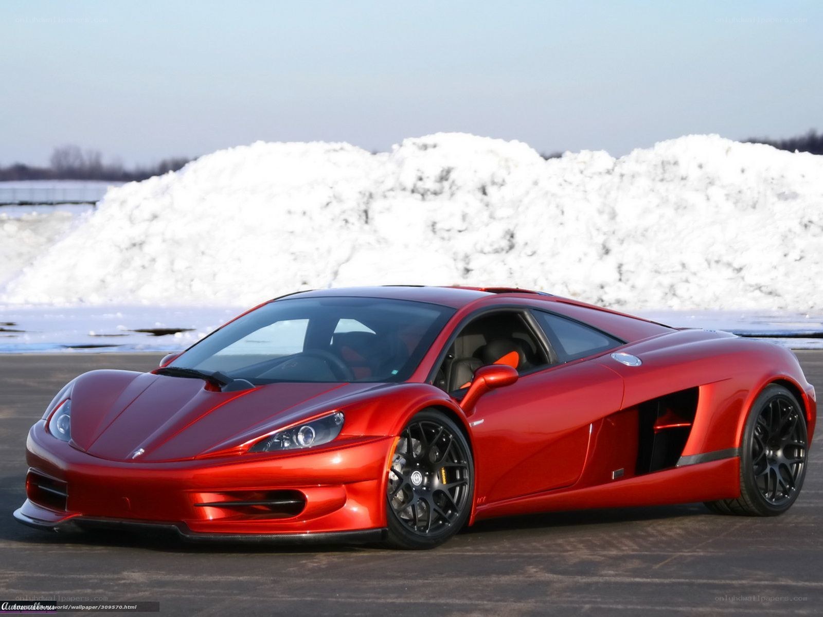 Red sports car on snowy lot