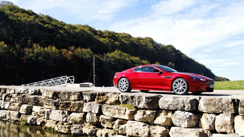 Red sports car on stone pier
