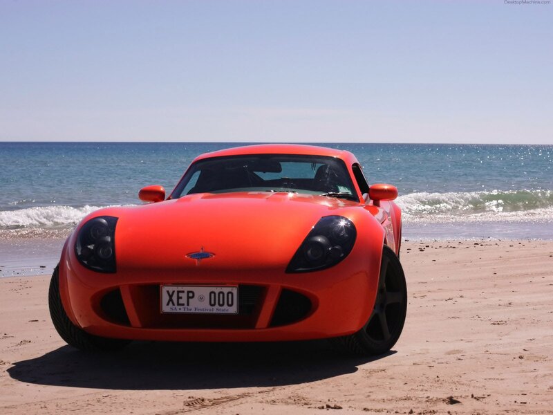 Red sports car on the beach
