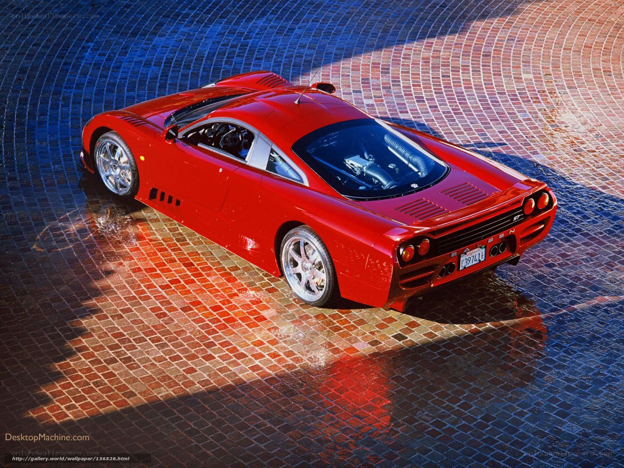 Red sports car on tiled surface