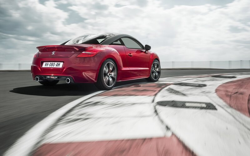 Red Sports Car on Track — Dynamic, Photograph, Race Track, Cloudy Sky
