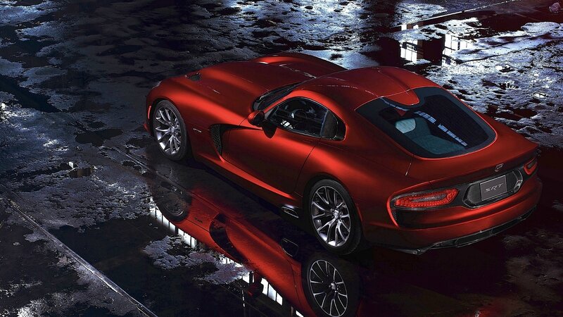 Red sports car on wet pavement