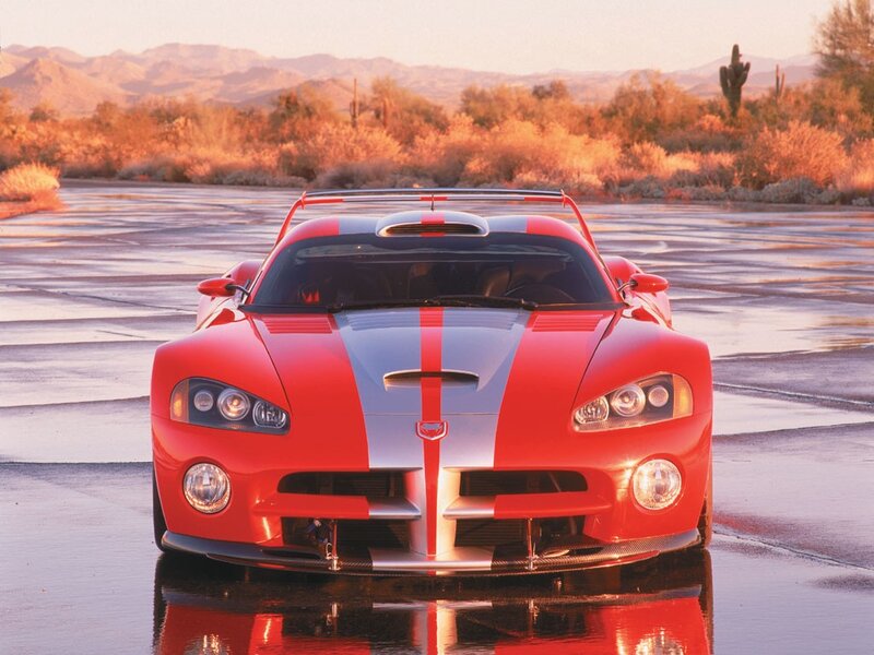 Red sports car on wet pavement