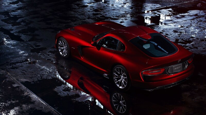 Red sports car on wet pavement