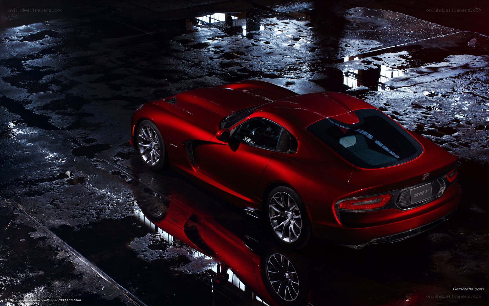 Red sports car on wet pavement
