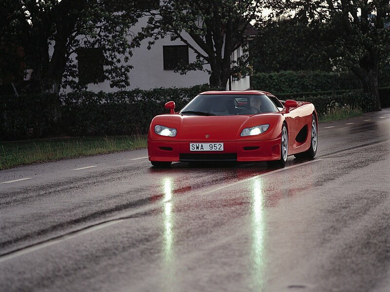 Red sports car on wet road