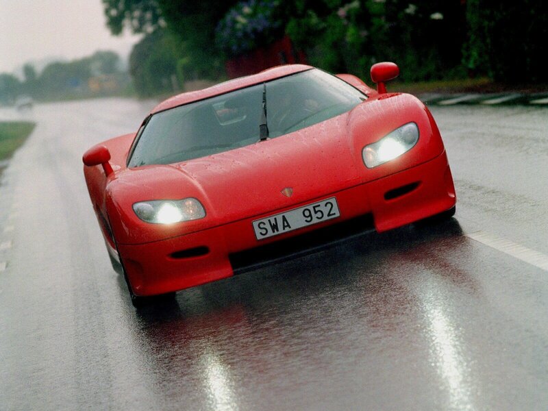 Red sports car on wet road