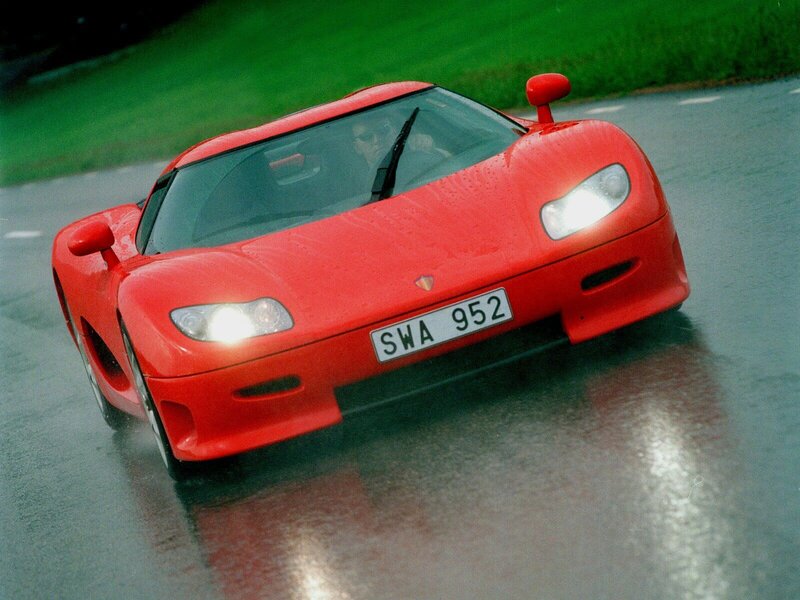 Red sports car on wet road