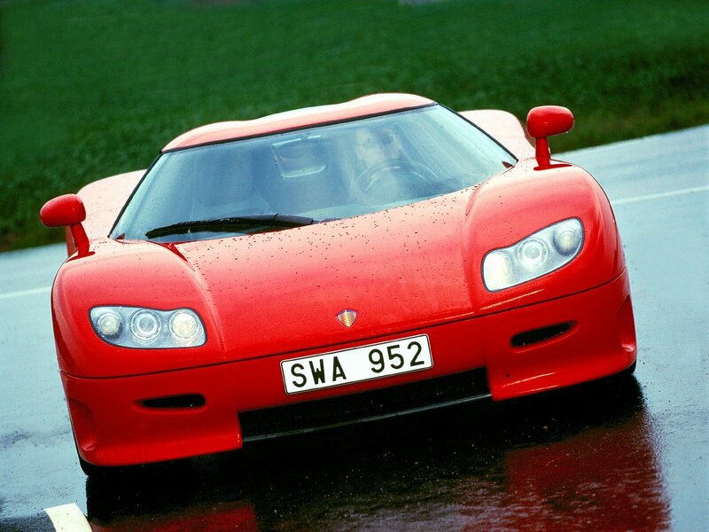 Red sports car on wet road