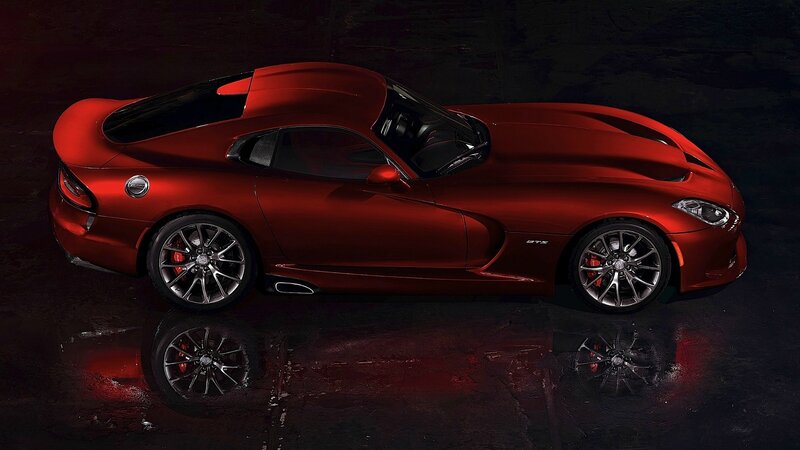 Red sports car on wet surface