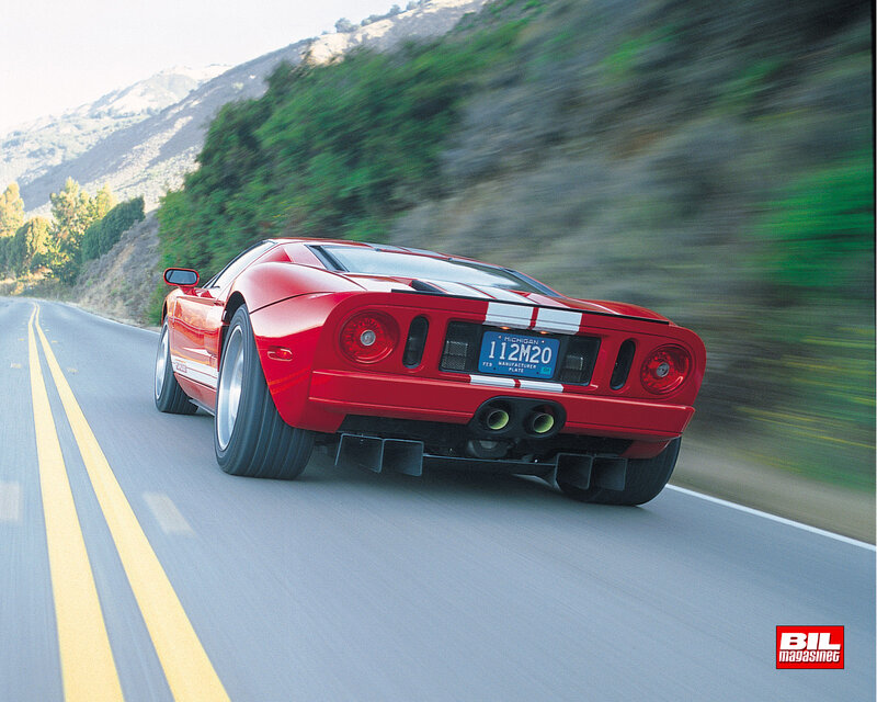 red sports car on winding road