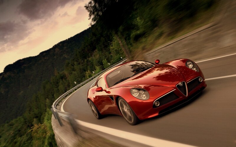 Red sports car on winding road