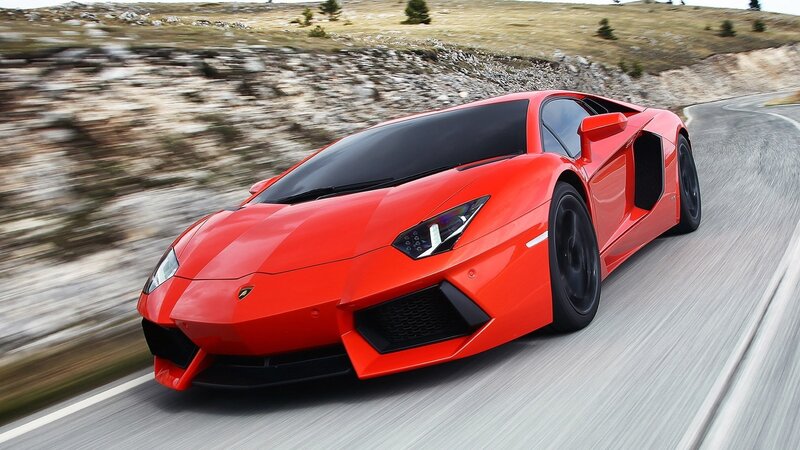 red sports car on winding road