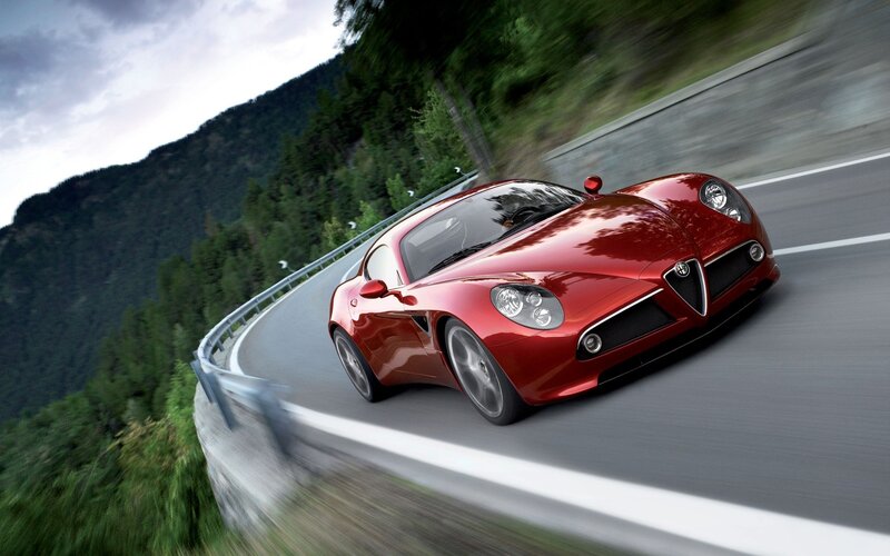 Red sports car on winding road