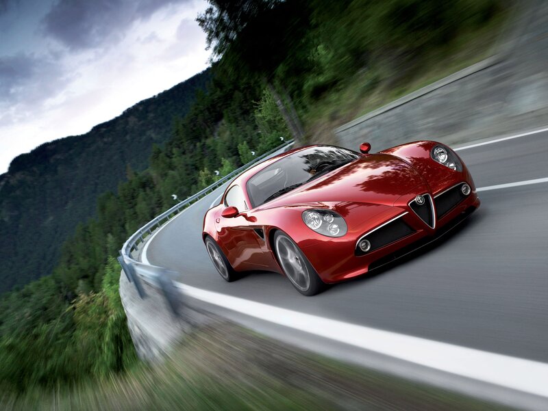 Red sports car on winding road
