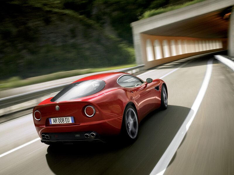 red sports car on winding road