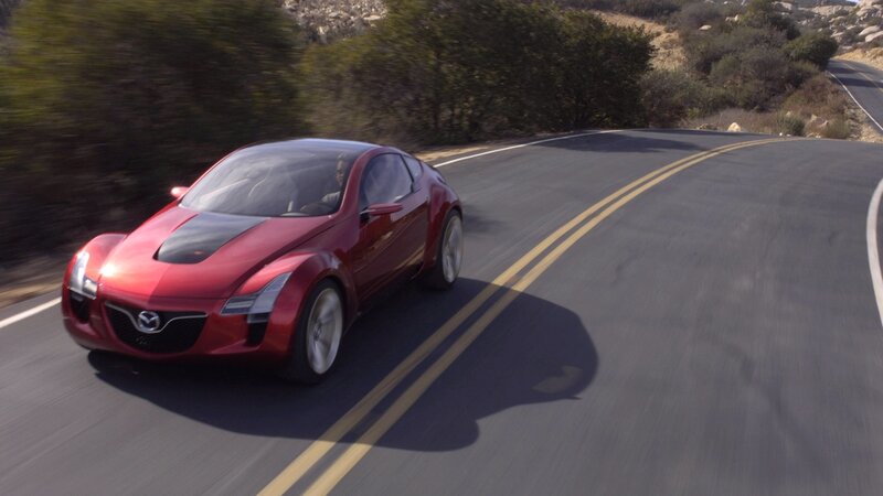 Red sports car on winding road