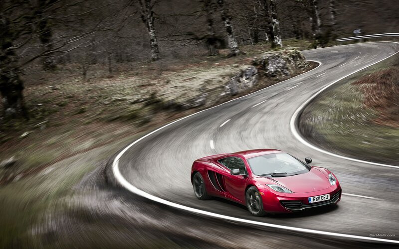 red sports car on winding road