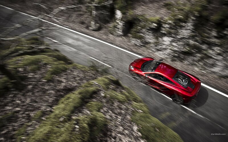 Red sports car on winding road