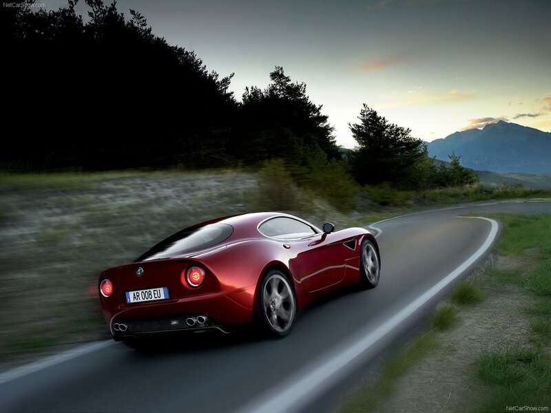red sports car on winding road
