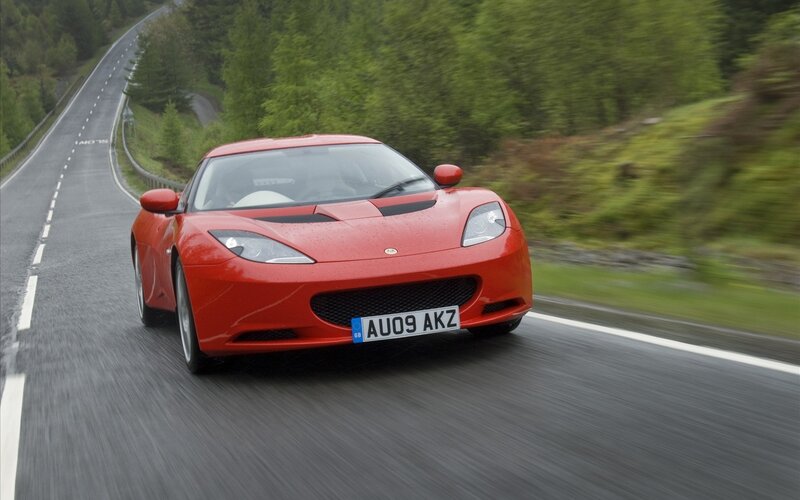 red sports car on winding road