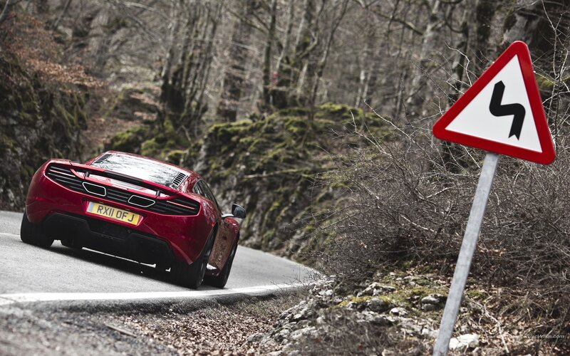 Red sports car on winding road