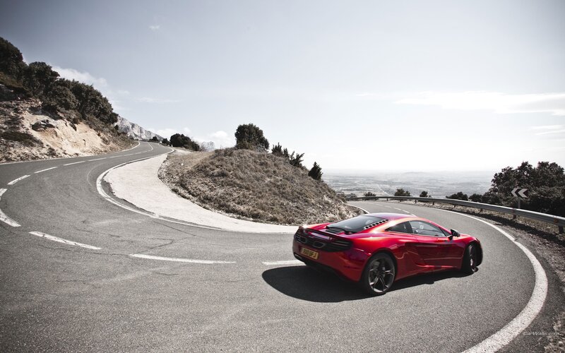 Red sports car on winding road