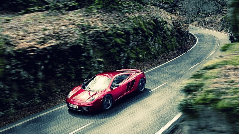 red sports car on winding road