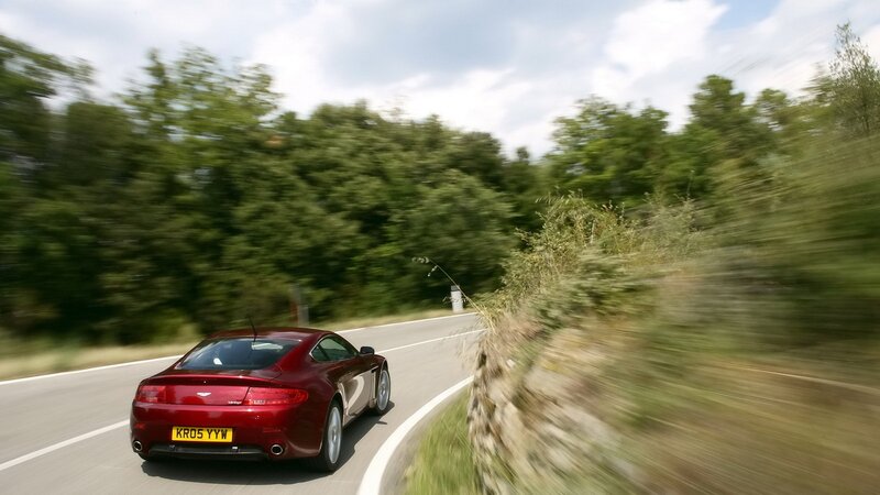 red sports car on winding road