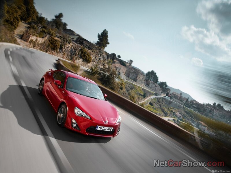 red sports car on winding road
