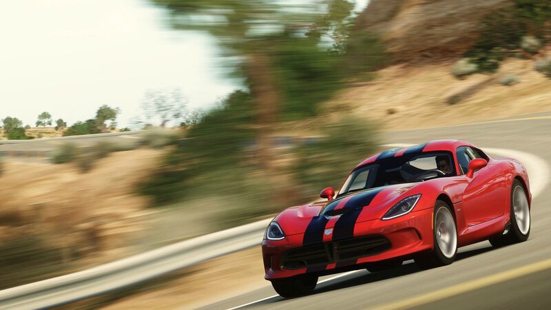red sports car on winding road