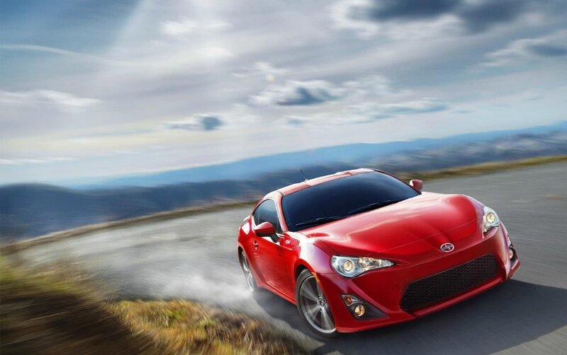 Red sports car on winding road