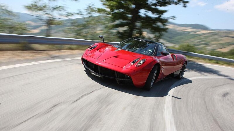 red sports car on winding road