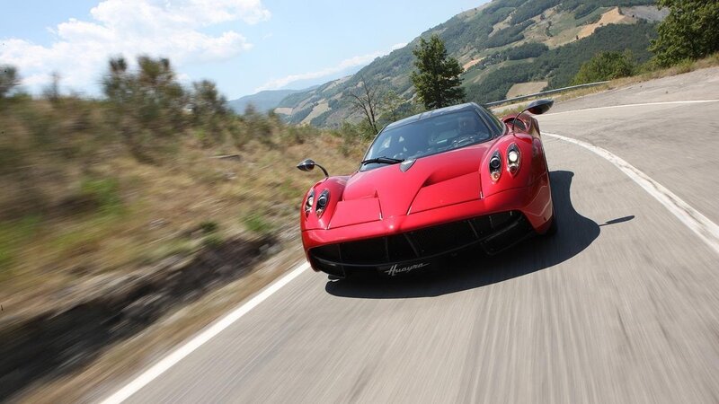 red sports car on winding road